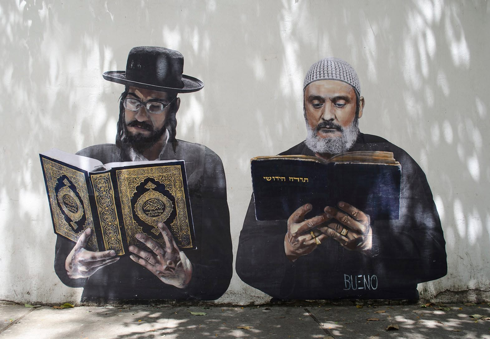 Mural showing a Jewish man and a Muslim man studying side by side